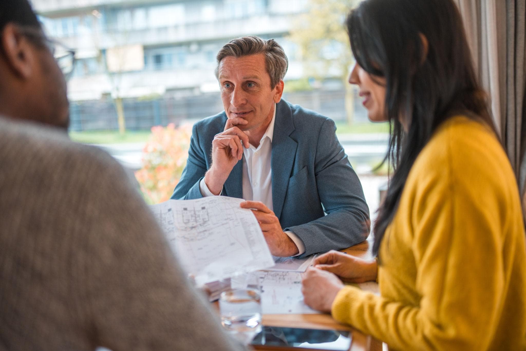 An advisor guiding an international client through the property-buying process